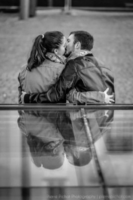 A couple kissing, with a nice reflection.