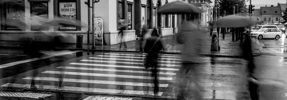 People commuting from work to home... and under the rain. Cluj-Napoca, Romania, 2014.