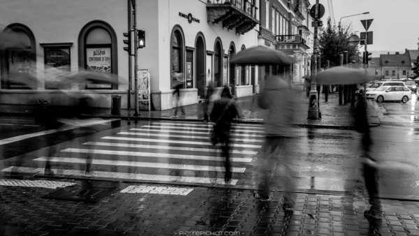 People commuting from work to home... and under the rain. Cluj-Napoca, Romania, 2014.