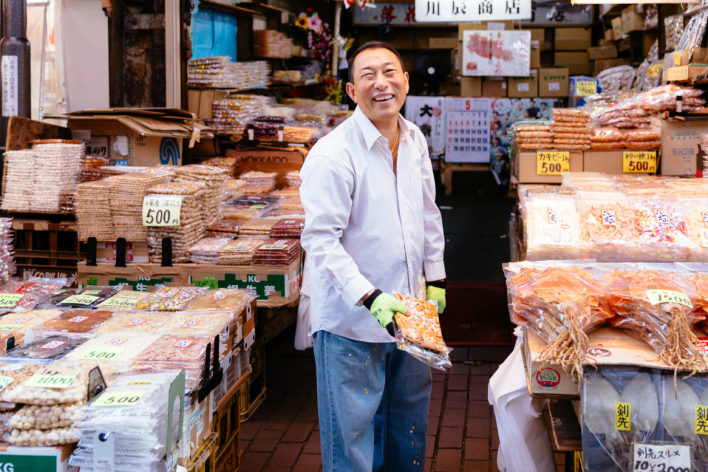 A smily dry fish seller in Ameyoko shopping street, Ueno, Tokyo, Japan.