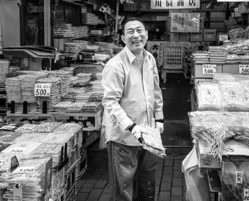 Smily dry fish seller in Ameyoko shopping street, Ueno, Tokyo, Japan.